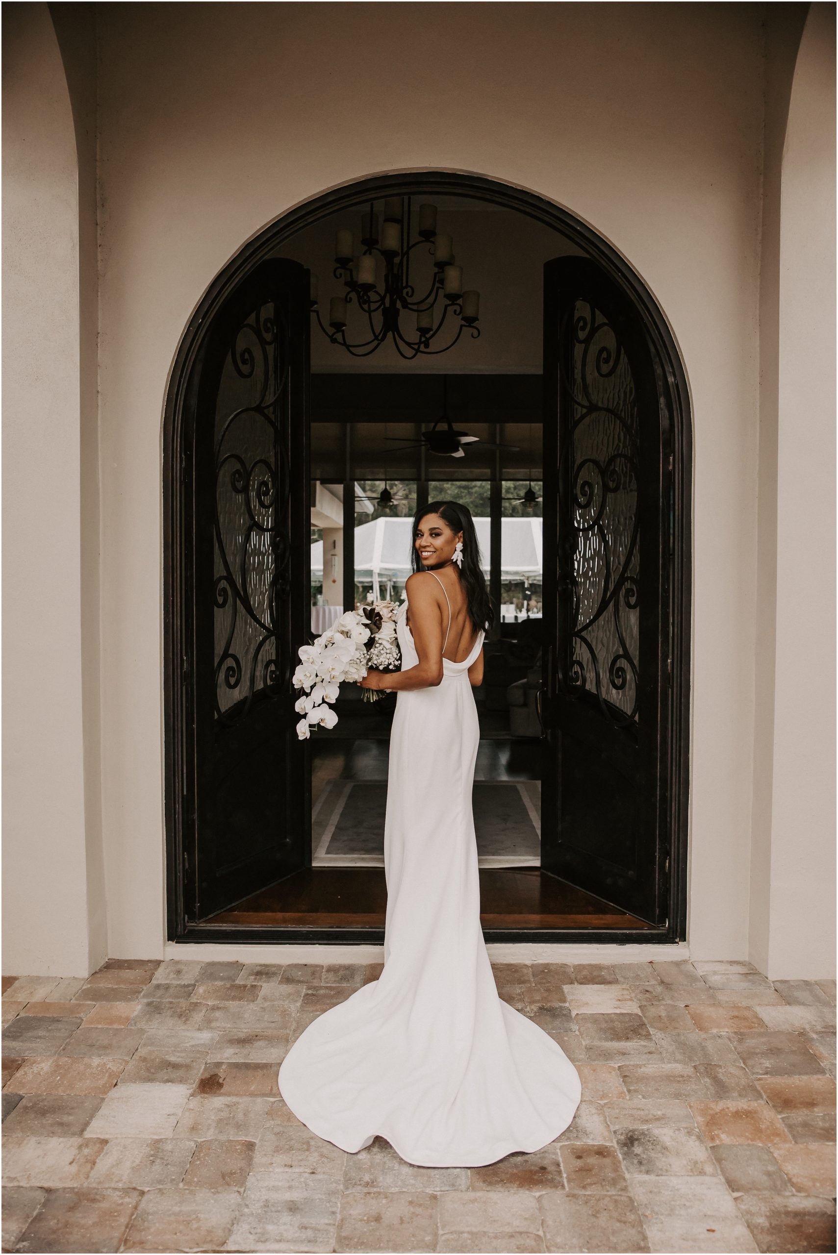 Bride Colby found her dream wedding dress at Love Bridal Boutique. As a result, the deep neckline on the back and the form-fitted silhouette were paired perfectly with her dreamy bouquet.