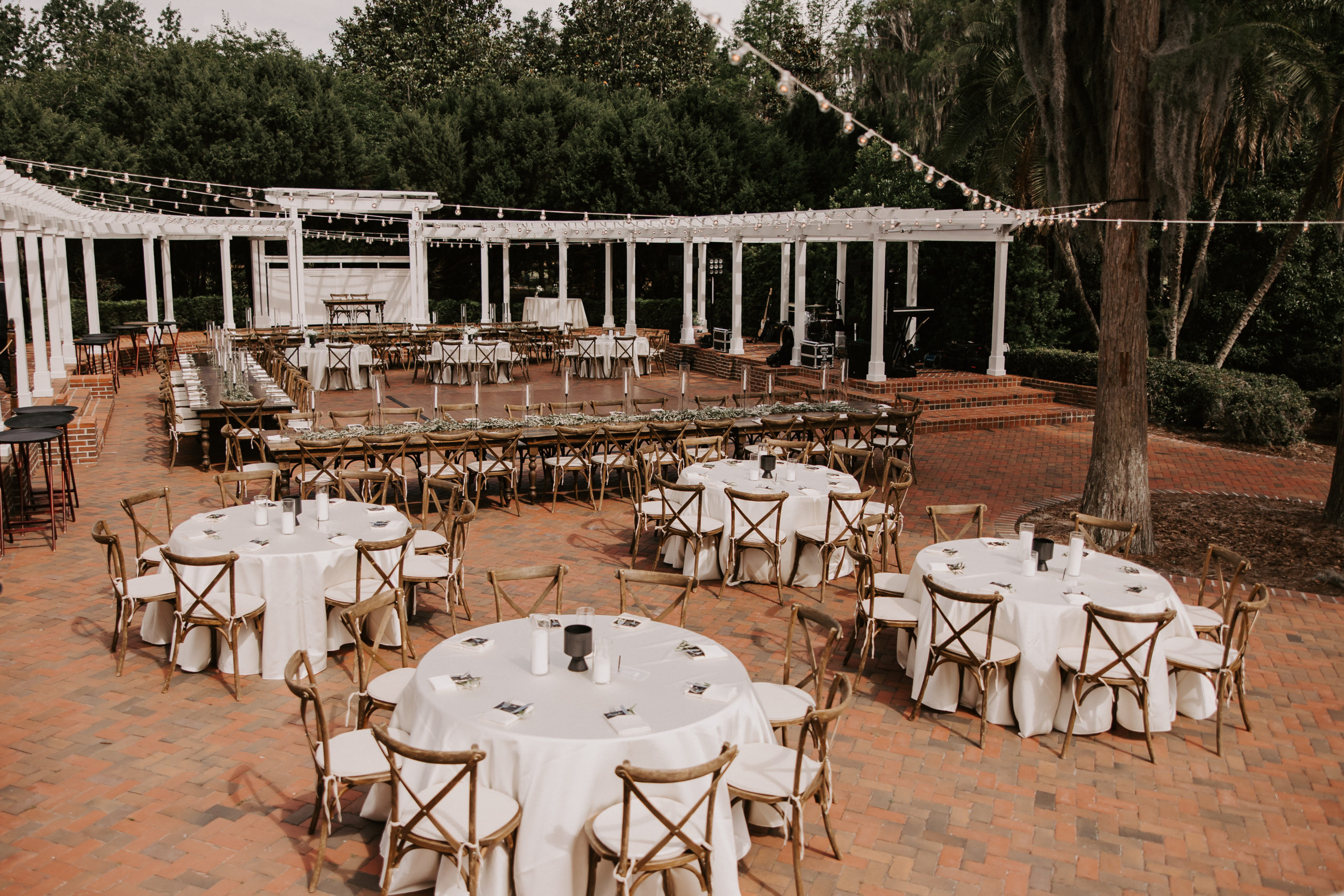 For the reception of this distinguished garden wedding, round and rectangular tables were the perfect mix together with lush greenery garlands spanning the table length and centerpieces with blooms that brought on romantic vibes. 